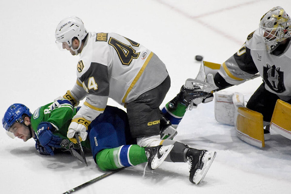 Abbotsford’s Tristen Nielsen is cross-checked in front of the net on Saturday (March 16). (Ben Lypka/Abbotsford News) 