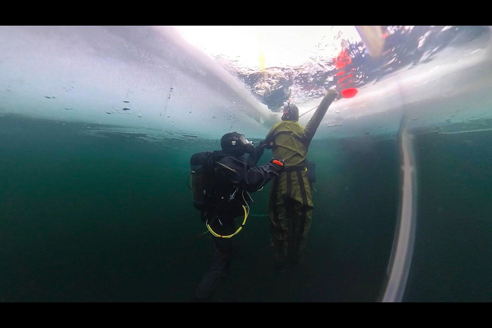 A diver swims under the ice of Sheridan Lake earlier this month. (Cpl Antoine Brochu photo - Canadian Forces Combat Camera) 