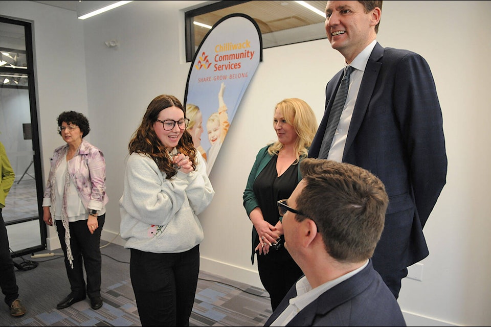 Tenant Alexandria Mui, 19, speaks with local MLAs Kelli Paddon and Dan Coulter, plus B.C. Premier David Eby, at The Paramount during the official opening for the six-storey, low-income housing project on Tuesday, March 19, 2024. (Jenna Hauck/ Chilliwack Progress) 