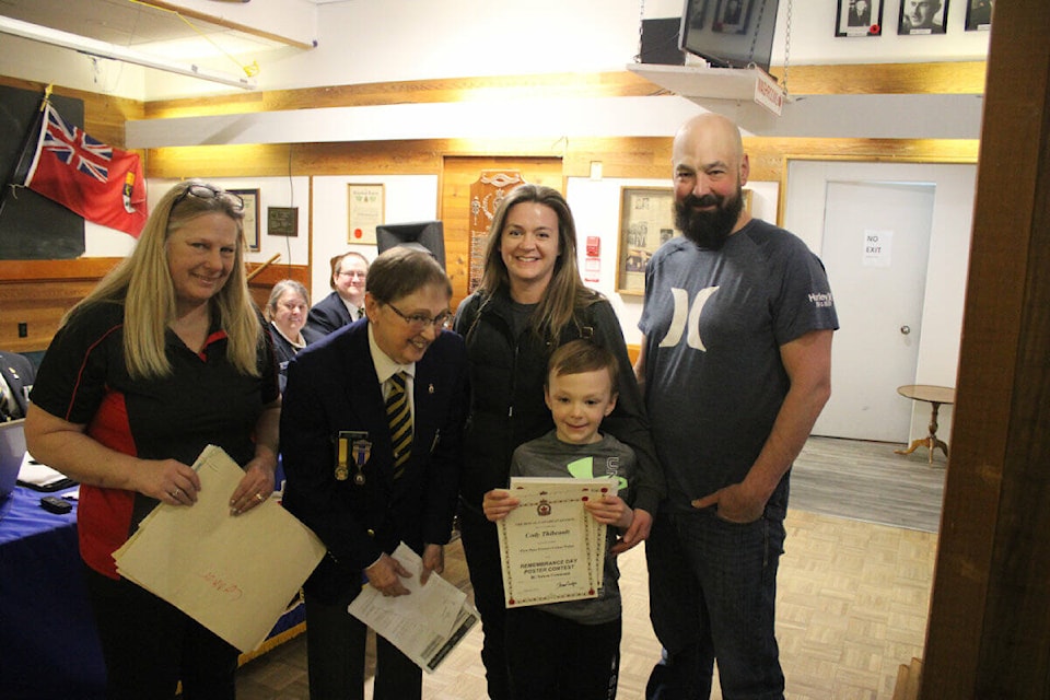 Royal Canadian Legion Branch 260 members Tracy Allard (left) and Diane Dulmage congratulate Crystal Thibeault, Cody Thibeault and Andrew Thibeault for Cody’s success in their poster contest. (Misha Mustaqeem photo - 100 Mile Free Press) 
