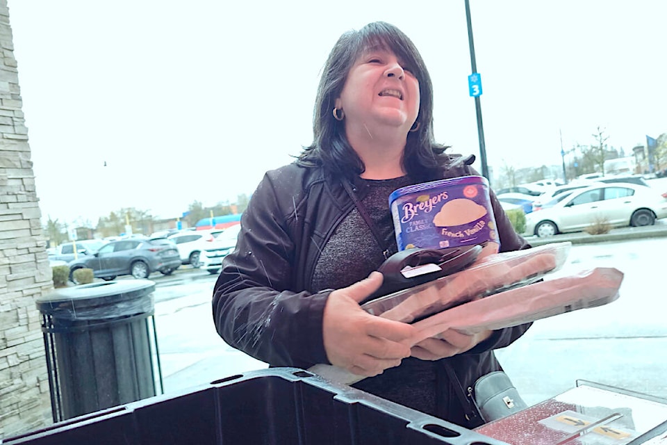 A Walmart shopper dropped off a donation for the Langley Food Bank on Saturday, March 23(Dan Ferguson/Langley Advance Times) 
