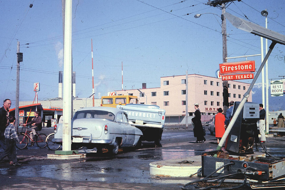 Gas pumps at the Texaco station on Third Avenue near Redford Street sit destroyed and vehicles are piled on top of each other the day after the 1964 tsunami hit Port Alberni. (JAN JANSMA PHOTO) 