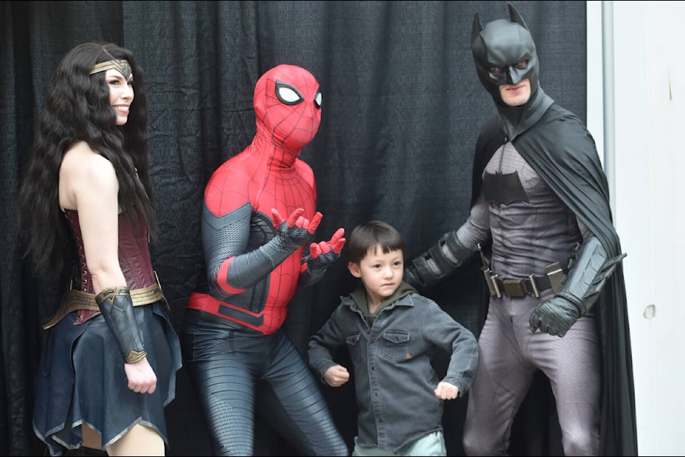A youngster poses with Wonder Woman, Spider-Man and Batman at the Heroes Day event at Sevenoaks Shopping Centre on Friday (March 22). (Ben Lypka/Abbotsford News) 