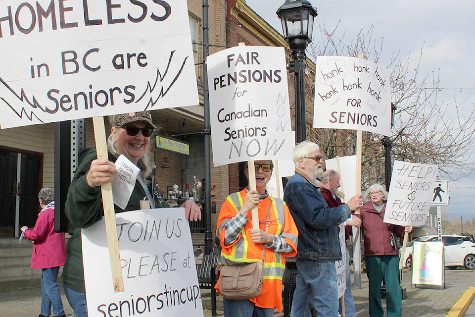 Rhonda Shirley, front left, Maureen Pietrzykowski and other seniors protest along Ladysmith’s 1st Avenue as part of a province-wide Tin Cup March for Fair Seniors Pensions. (Greg Sakaki photo) 