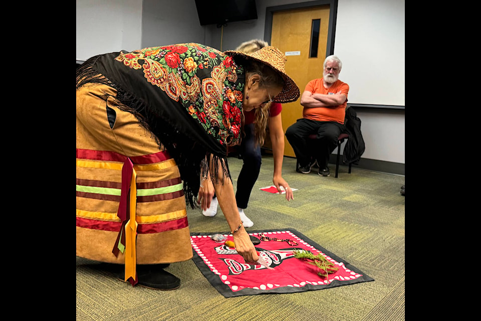 Carol Peters and Diane Garner lay items of personal importance to them on a blanket prior to a sharing circle as part of the KAIROS blanket exercise. (Jessica Peters/Black Press Media) 