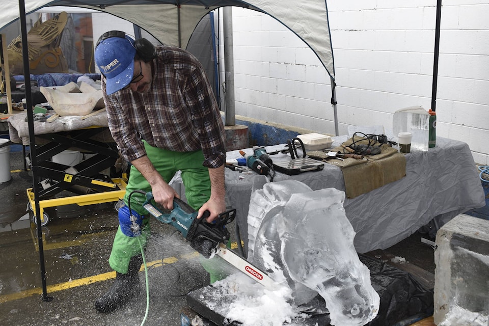 Aaron Grant started working on his ice sculpture at 10:30 a.m. on Saturday, March 23, as he made his first appearance at Ignite the Arts’ sculpture day. (Logan Lockhart/Western News) 