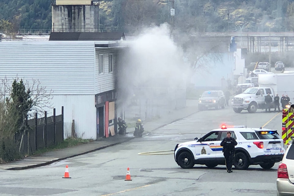 The Port Alberni Fire Department responds as smoke pours from a building on Burde Street on March 27, 2024. (ELENA RARDON / Alberni Valley News) 