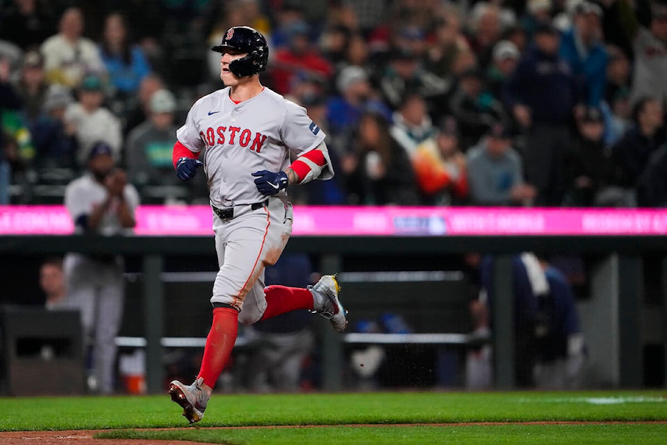 Boston Red Sox’s Tyler O’Neill nears home after hitting a home run against the Seattle Mariners during the eighth inning of an opening-day baseball game Thursday, March 28, 2024, in Seattle. (AP Photo/Lindsey Wasson) 