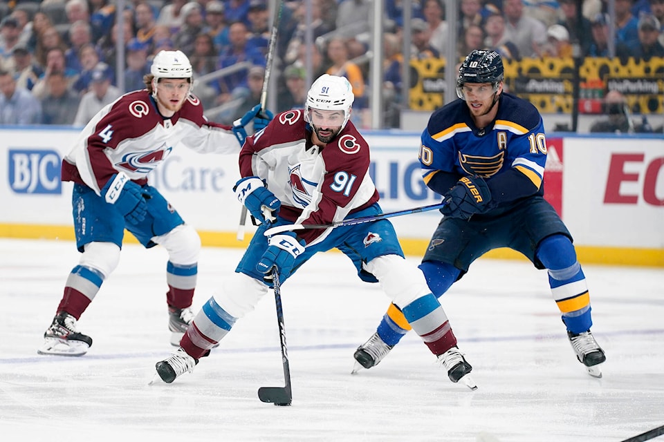 Colorado Avalanche’s Nazem Kadri (91) brings the puck down the ice as St. Louis Blues’ Brayden Schenn (10) defends during the first period in Game 4 of an NHL hockey Stanley Cup second-round playoff series Monday, May 23, 2022, in St. Louis. For which team does Kadri now play? (AP Photo/Jeff Roberson) 
