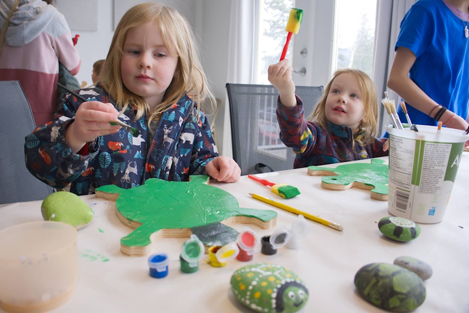 Tia Hughes and River Tamas create their own painted turtles during White Lake Turtle Fest at the White Lake Community Hall on Saturday, April 15, 2023. (Salmon Arm Observer photo)  