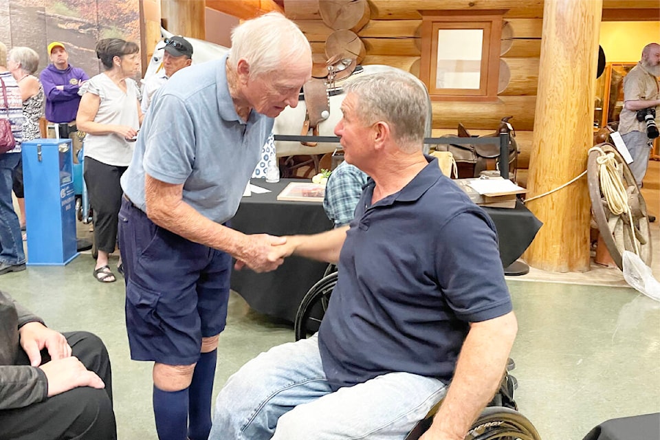 Rick Hansen shakes the hand of the doctor who helped save his life after his spinal cord injury in a motor vehicle crash fifty years ago. (Ruth Lloyd photo - Williams Lake Tribune) 