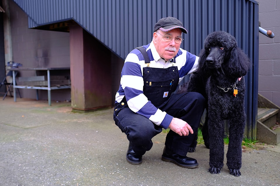 Ross Lane, 76, was diagnosed with Parkinson㽶Ƶֱs disease in early 2023. He poses beside Jet, his 12-year-old black poodle. (Olivier Laurin / Comox Valley Record) 
