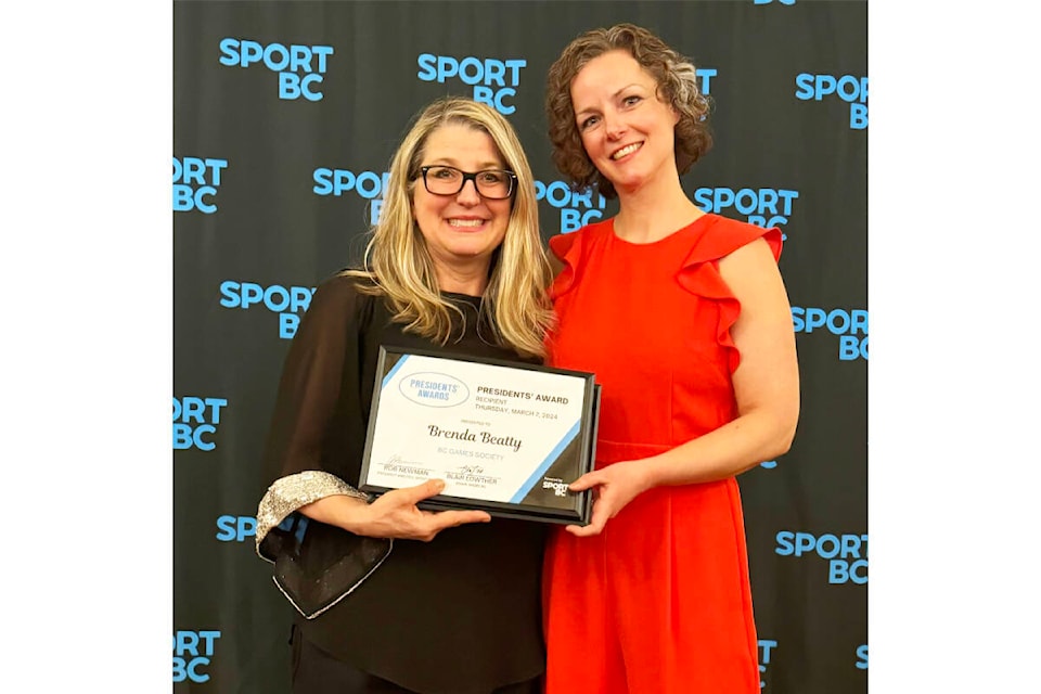 Minister of sport Lana Popham (left) presents Quesnel’s Brenda Beatty with a Sport BC President’s Award on behalf of the BC Games Society. Beatty and Brian Balkwill (unable to attend the ceremony) were honoured for their work leading the Lhtako Quesnel BC Winter Games organization. (Photo submitted) 
