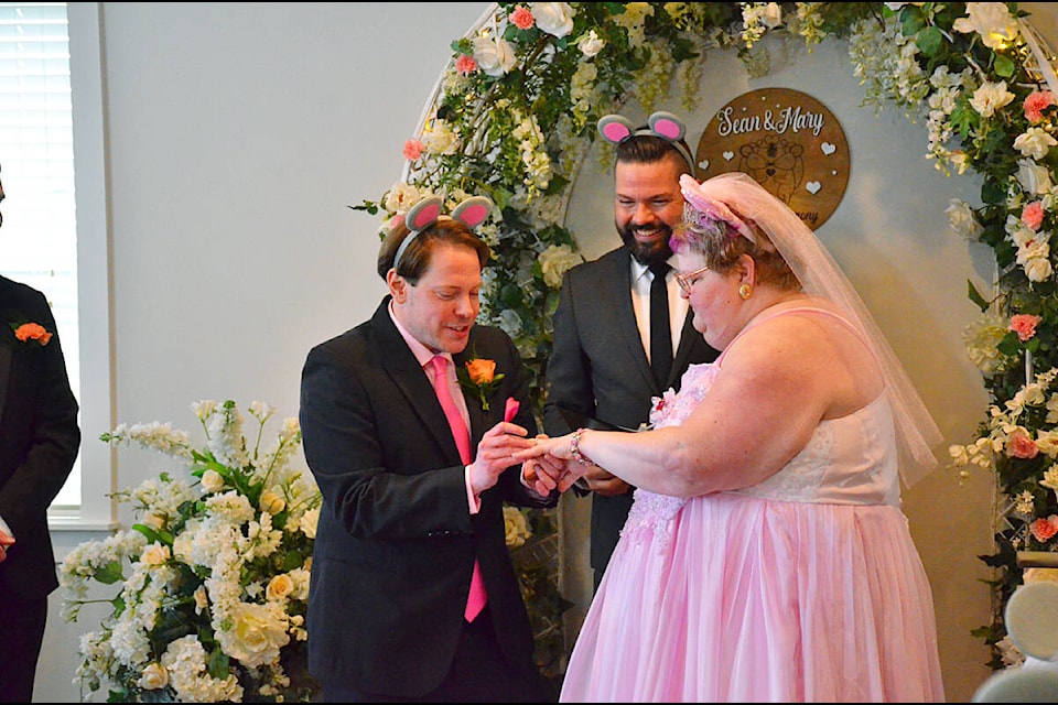 Sean Adelberg slips the ring on Mary Davidson’s ring during their wedding on tuesday, April 2 at Campbell River’s Hospice House. Photo by Alistair Taylor/Campbell River Mirror 