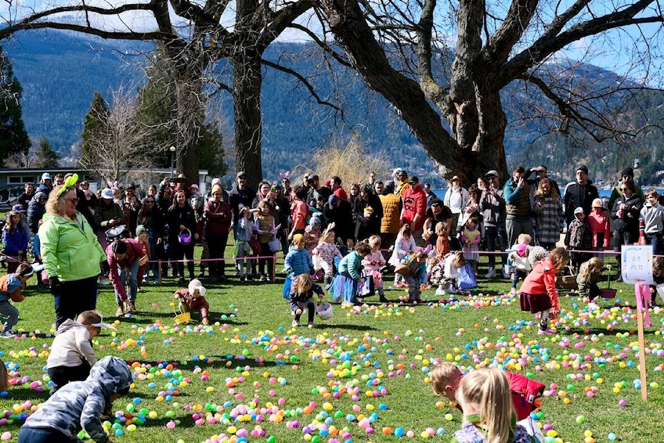 Children and Mayor Janice Morrison gather eggs on Easter Sunday at Lakeside Park in Nelson. Photo: Bill Metcalfe 