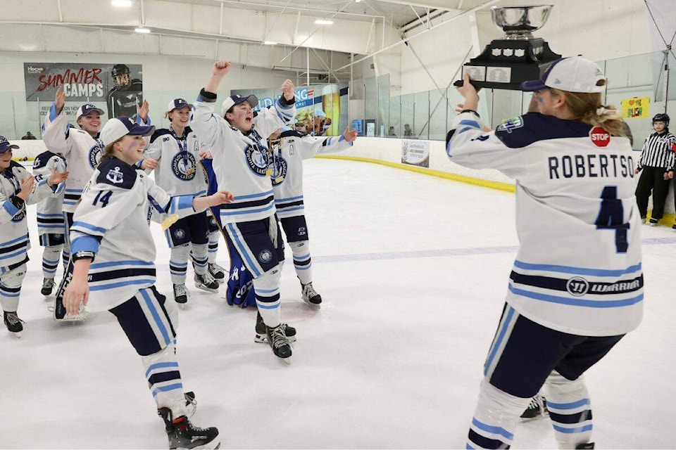 Captains Hannah Robertson and Holly Magnus bring cup to teammates, after defeating the Fraser Valley Rush in game three of the championship series. (Garrett James Photography) 