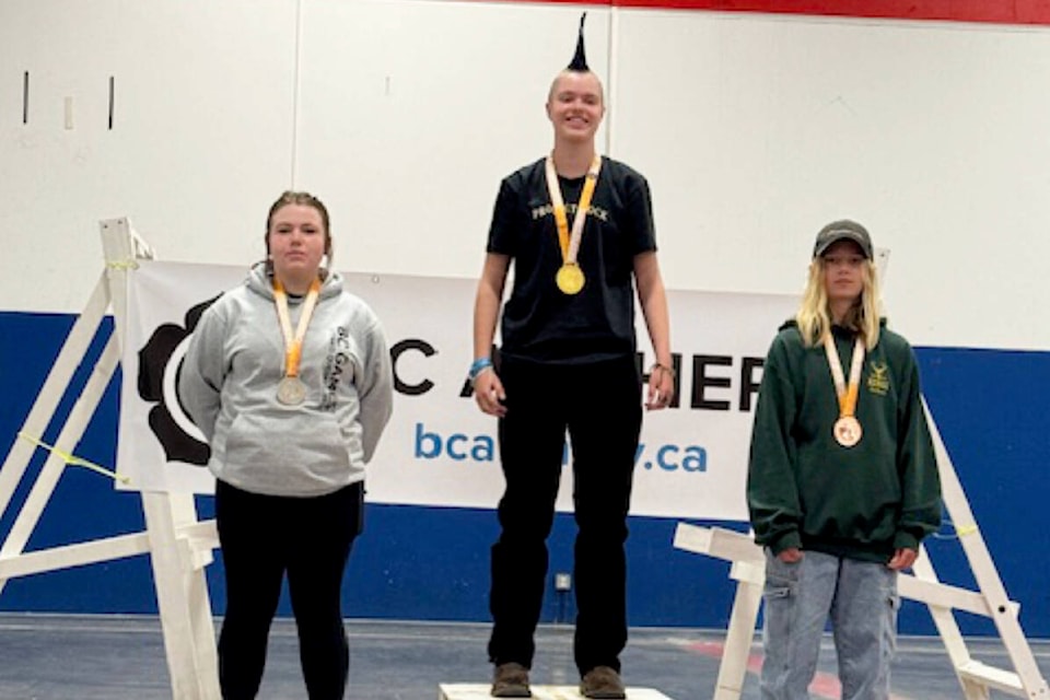 Lily Fraser, centre, stands on top the podium after winning gold in Maple Ridge over Easter weekend. (Photo submitted) 