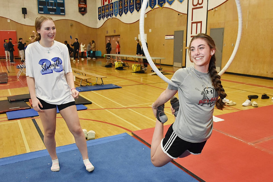 Grade 12 students Jenna Hampton, left, and Sheridan Sinow, were drawn to the aerial rings, part of the aerial setup that also included a stable trapeze and silks. (Colleen Flanagan/The News) 