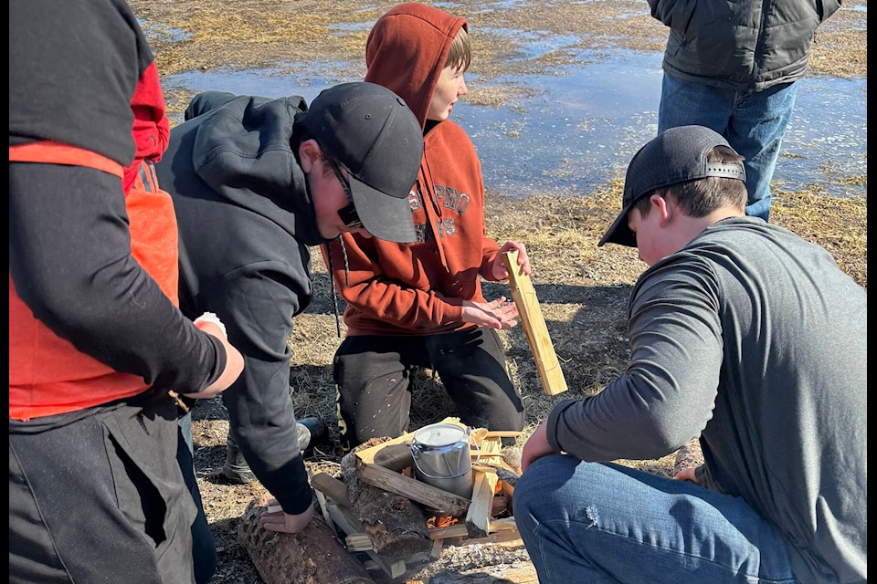 A group of youngsters boil a pot of snow to make tea at Enterprise’s 2024 spring carnival. The carnival was “great fun,” according to mayor Sandra McMaster. Photo courtesy of Sandra McMaster 