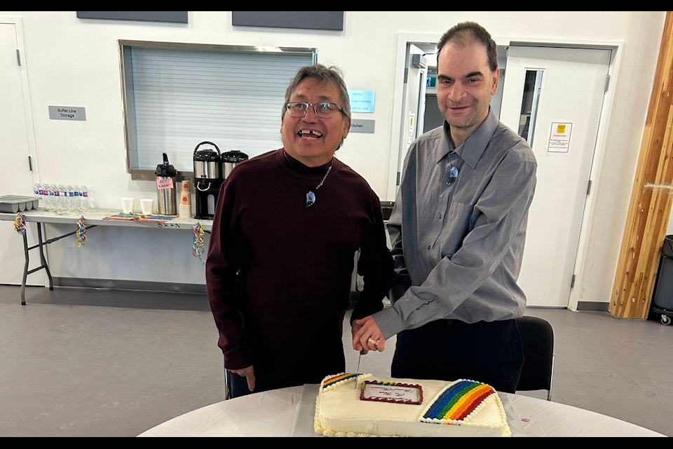 From left, Mark Moberly and Russell Selfie cut a cake after getting married at the first LGBTQ+ awareness supper in Fort Smith. “It was so good and beautiful,” says Selfie. Photo courtesy of Connie Benwell 