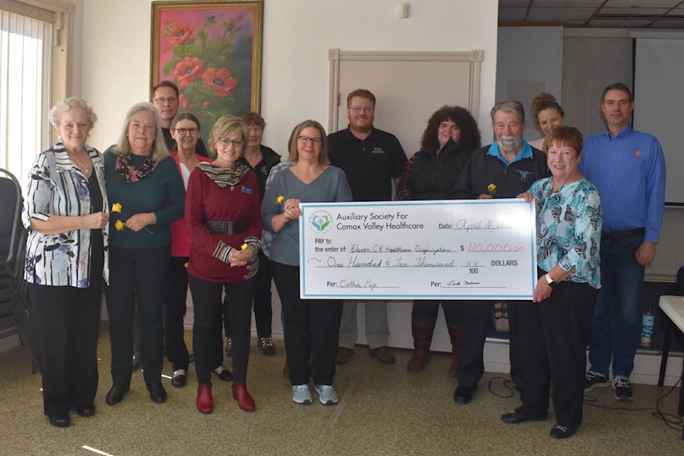 Representatives from the 11 Comox Valley groups pose with Auxiliary Society for Comox Valley Healthcare president Cathie Poge (front right) for a photo after receiving $10,000 each in celebration of the ASCVH’s 110th anniversary. Photo by Terry Farrell/Comox Valley Record 