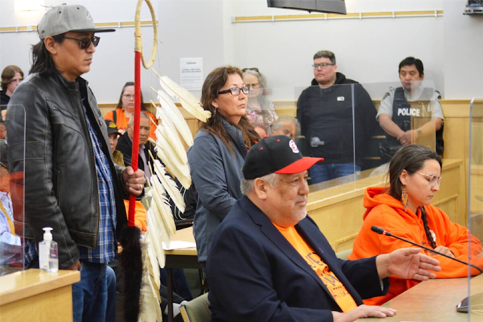 Chief Clifford Lebrun of the Lhtako Dene First Nation and chief Leah Stump of the Nazko First Nation (L to R, seated) led the procession of Indigenous leaders, elders and other others from the community who largely called for the resignation of Quesnel mayor Ron Paull. (Frank Peebles photo - Quesnel Cariboo Observer) 
