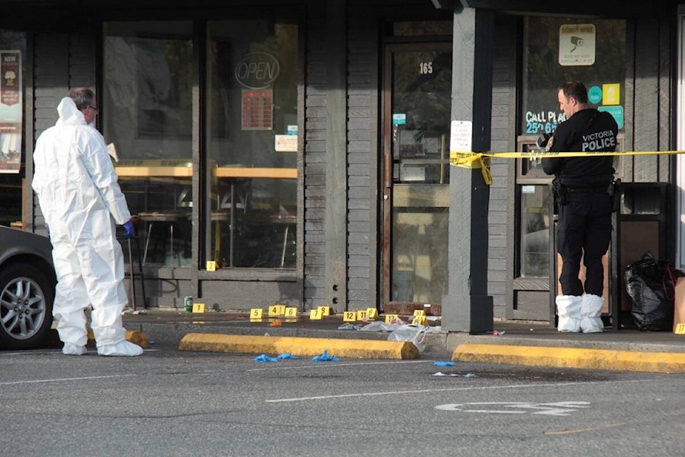 Forensic markers dot the sidewalk in Douglas Plaza as Victoria police investigate in the 2900-block of Douglas Street the morning of April 10. (Christine van Reeuwyk/News Staff) 