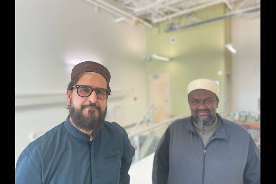 Nazim Awan, left, and Habib Hassan stand outside the gymnasium at Ecole Allain St. Cyr on Friday. Awan said that, largely, YellowknifeSAӰӴýs community has been very welcoming. Devon Tredinnick/NNSL photo 