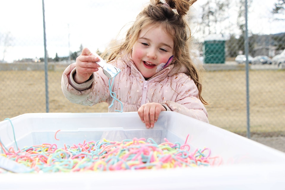 Kylie Meszaros plays with some coloured spaghetti on Saturday, April 6 at Blue Sky’s Autism Services Autism Acceptance Day. (Patrick Davies photo - 100 Mile Free Press) 