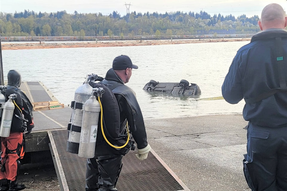 An RCMP dive team discovered a number of vehicles and a school bus submerged in the Fraser River while working to recover a stolen car on April 6, 2024. (Coquitlam RCMP) 