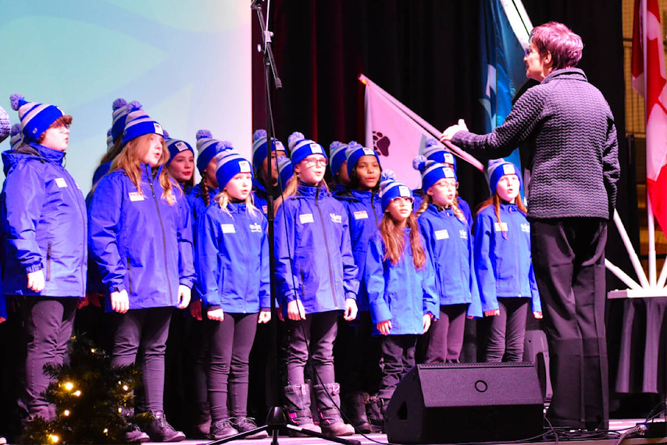 Quesnel’s award-winning InSong Youth Choir, led by director Melanie McKinnon, sang O Canada at the opening ceremonies of the Lhtako Quesnel BC Winter Games. (Frank Peebles photo - Quesnel Cariboo Observer) 