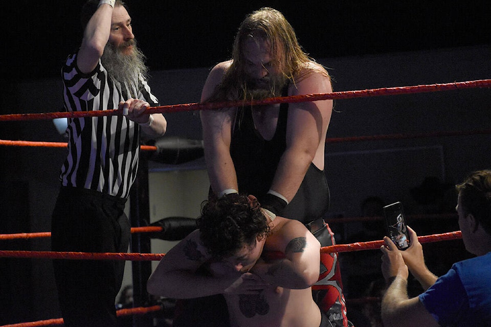 Nate Nixon chokes Josh Cadwell during All Star Wrestling action in Abbotsford on Saturday (April 13). (Ben Lypka/Abbotsford News) 