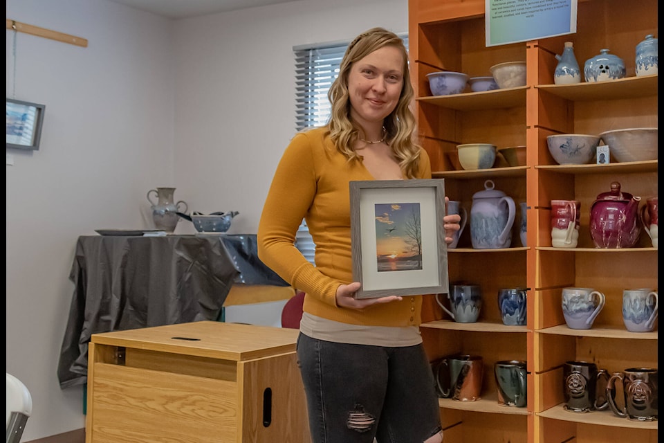 Taylor Hansen poses with a photograph print. (Photo courtesy, Phinlee Hansen) 