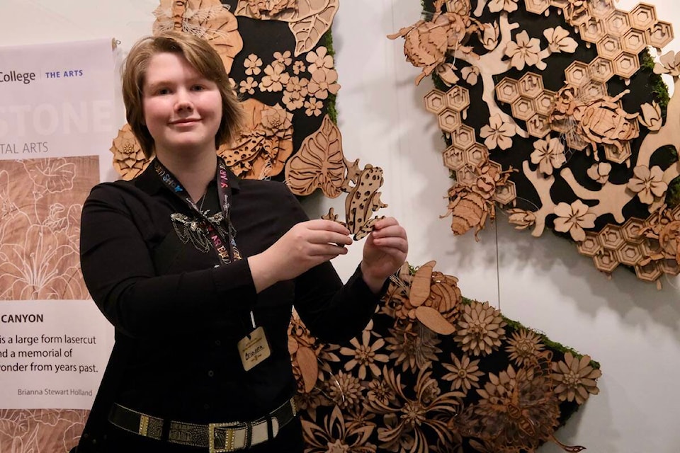 Brianna Stewart Holland made this laser-cut sculpture that celebrates her love of insects. On the table in front of her are dozens of individual insects like the one she is holding. “Ever since I was a kid I would love to play outside, flipping over logs, seeing what insects there are. I just love the way that they look, the way that they work. I find them so beautiful.” Photo: Bill Metcalfe 