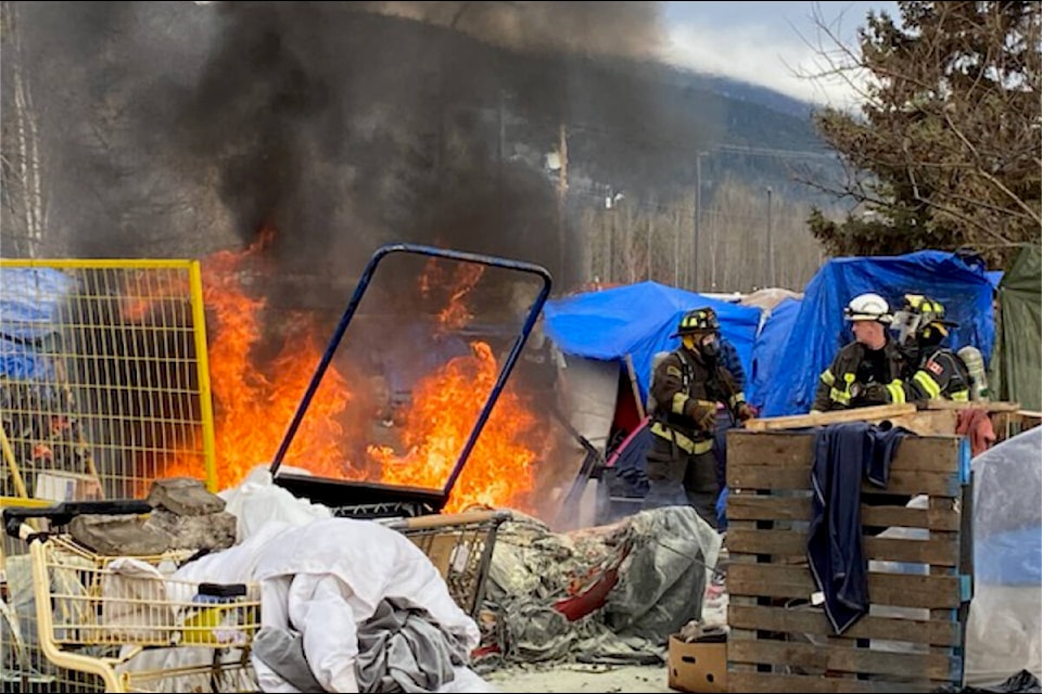 Firefighters battle a blaze at the homeless encampment across from Smithers town hall April 12. (Mary Kemmis/Black Press Media) 