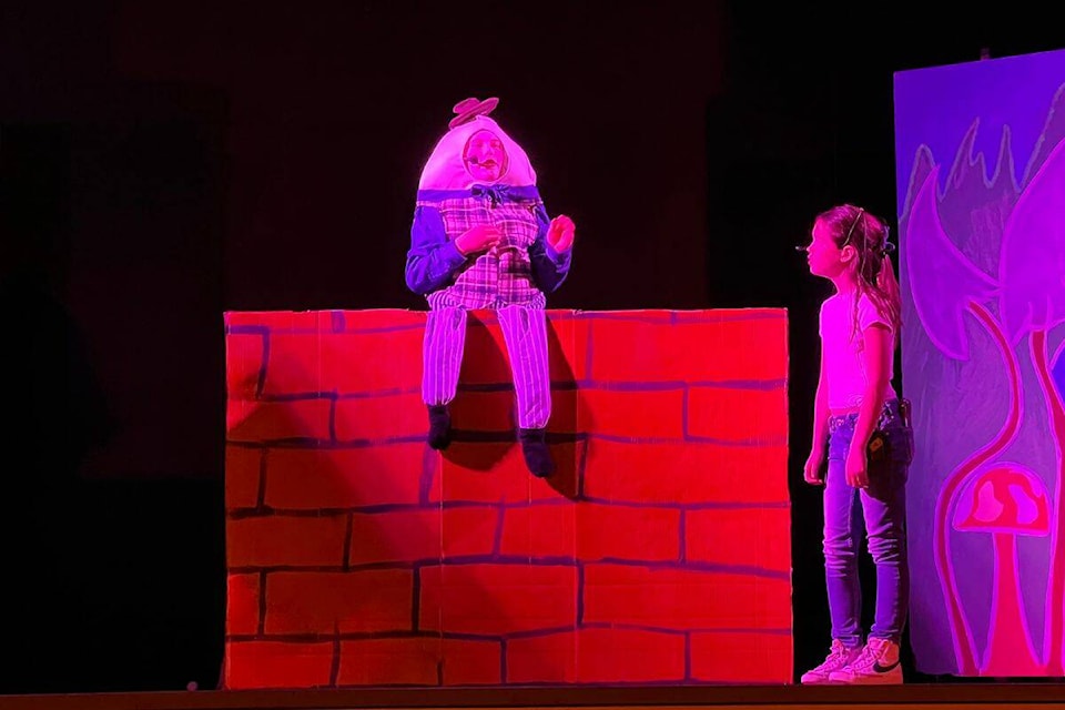 Alice #3 (Maci Thiessen) and Humpty Dumpty (Ryder Schubert) perform in the Alice in Wonderland play put on at BX Elementary. (Louise Alexander Photo) 
