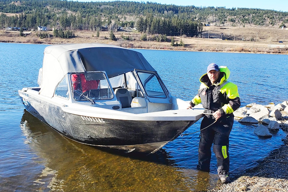 Dan St. Hilaire with the Ministry of Environment Provincial Lake Monitoring Program pulls a boat in after he and Mike Sokal, driving the boat, collect samples from Williams Lake Wednesday, April 17. (Monica Lamb-Yorski photo) 