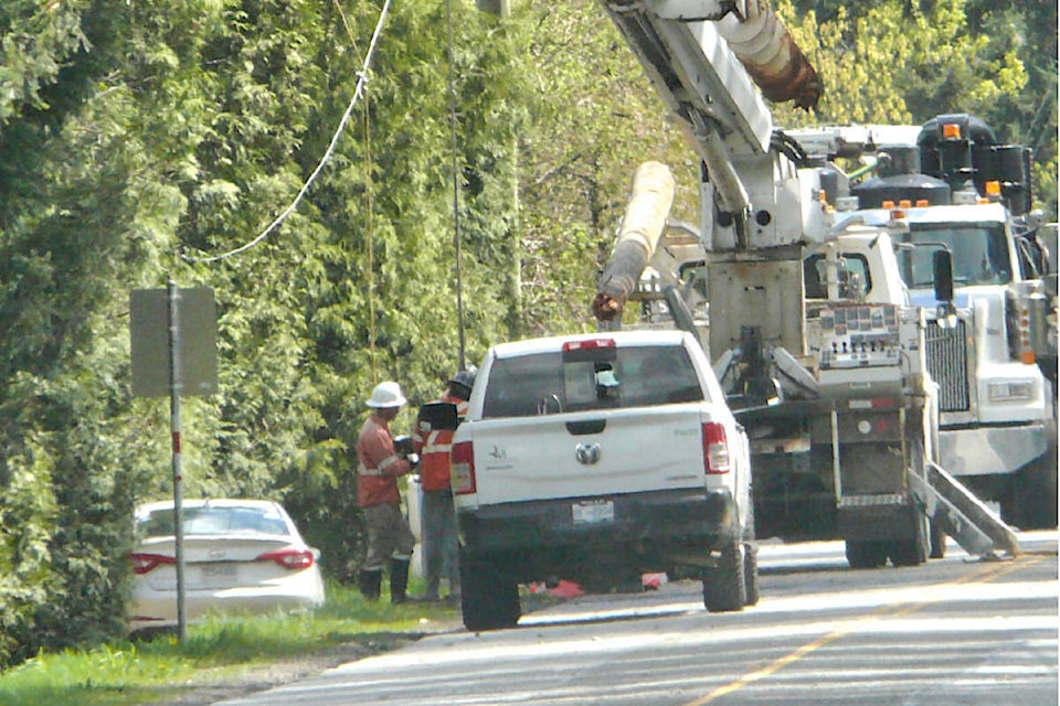  B.C. Hydro crews were working to replace a utility pole on 52nd Avenue west of 272nd Street that was taken out by a suspected impaired driver early Sunday morning, April 21, cutting service to 120 homes and forcing an all-day road closure. (Dan Ferguson/Langley Advance Times) 