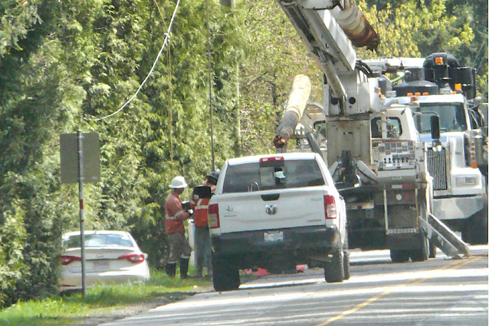  B.C. Hydro crews were working to replace a utility pole on 52nd Avenue west of 272nd Street that was taken out by a suspected impaired driver early Sunday morning, April 21, cutting service to 120 homes and forcing an all-day road closure. (Dan Ferguson/91ԭ Advance Times) 
