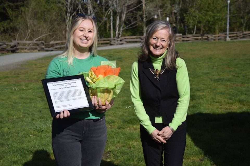 Severine Tyszewicz of the Victoria Green Team accepts the CENiC environmental stewardship award from Carol Brown at Colwood Creek Park. (New Staff/ Thomas Eley) 