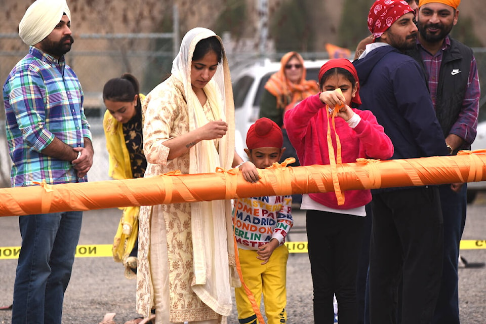 Part of Vaisakhi Day includes the cleaning and changing of the fabric of the flag pole, which is the symbol for a welcoming Sikh gathering place. The Guru Nanak Sikh Temple hosted Vaisakhi Day celebrations April 20. (Angie Mindus photo - Williams Lake Tribune) 