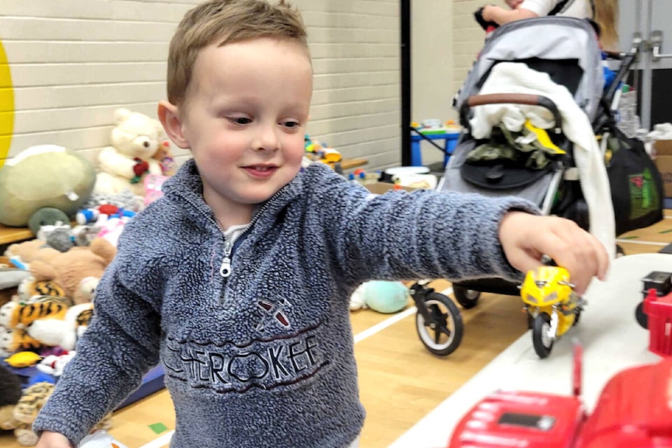 Emmett, three, tested out the toy trucks for sale at the 10th annual Dollar Sale at Shortreed Elementary on Friday, April 26. (Kyler Emerson/Langley Advance Times) 