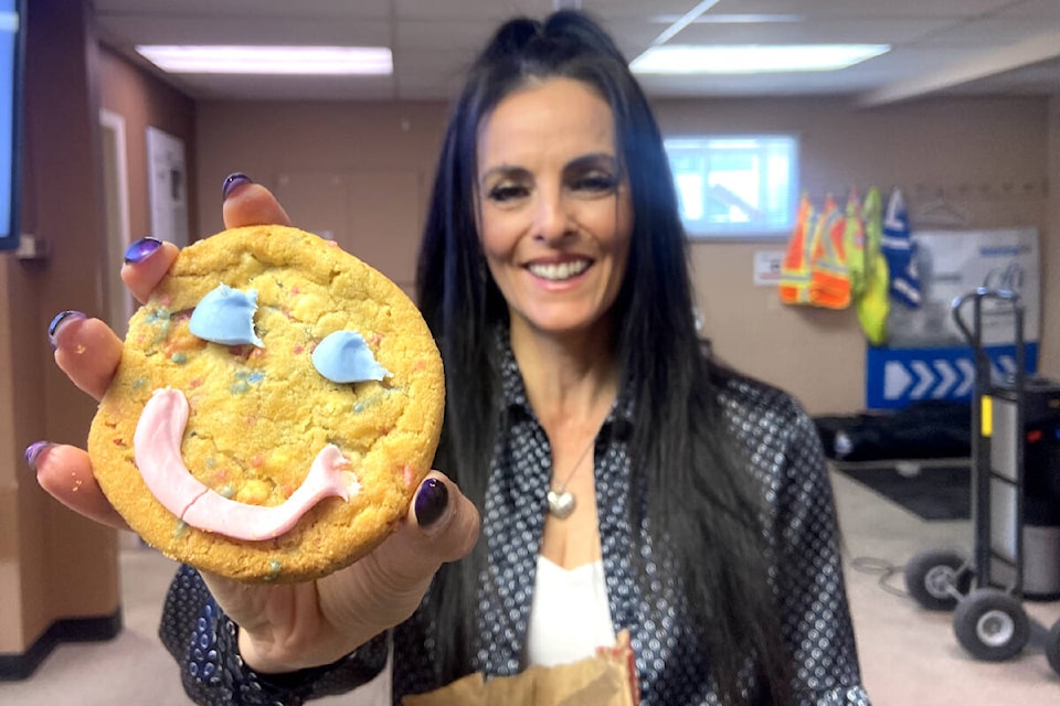 Stephanie Stecyk, Morning Star advertising manager, treats the news staff to Smile Cookies in support of the VJH Foundation. (Jennifer Smith - Morning Star) 