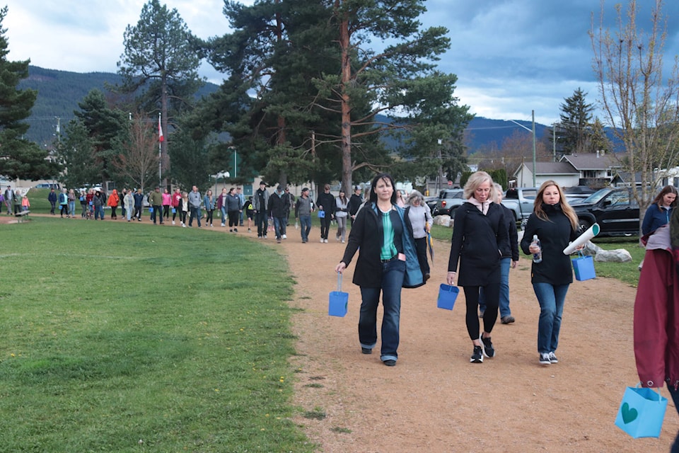 More than 200 people marched around Oval Park at a vigil honouring slain Lumby mother Tatjana Stefanski Friday, April 26, 2024. (Brendan Shykora - Morning Star) 