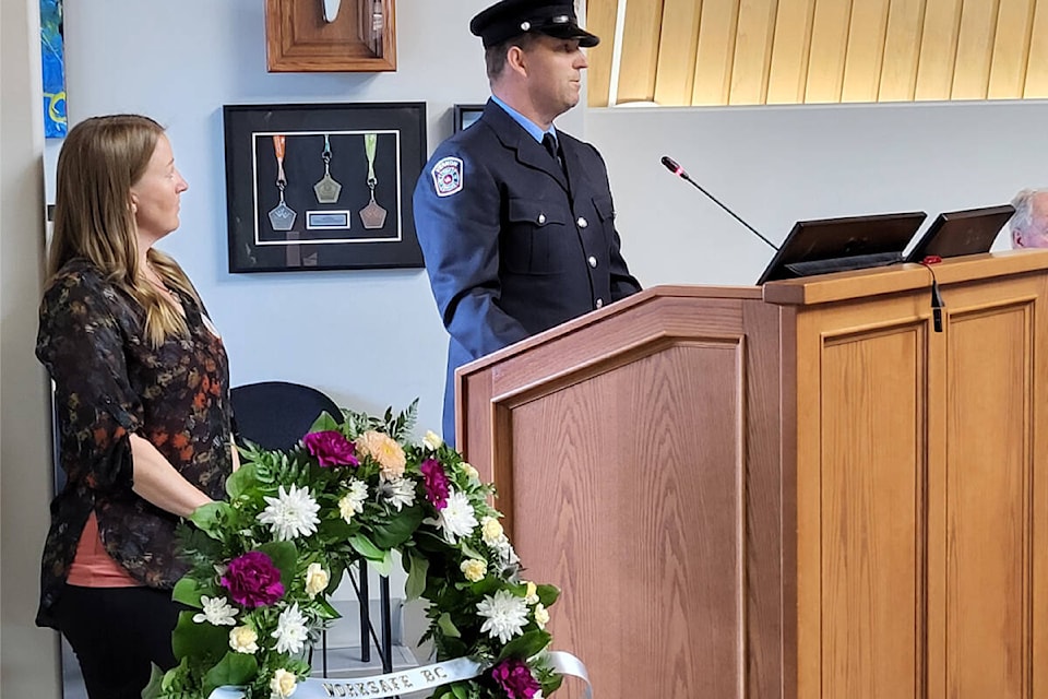 Vernon Fire Rescue Services firefighter John Doorman (right) addresses the crowd at the National Day of Mourning ceremony Friday, April 26, at Vernon City Hall. Looking on is ceremony host, City of Vernon occupational health and safety advisor Jennie Small. (Roger Knox - Morning Star) 