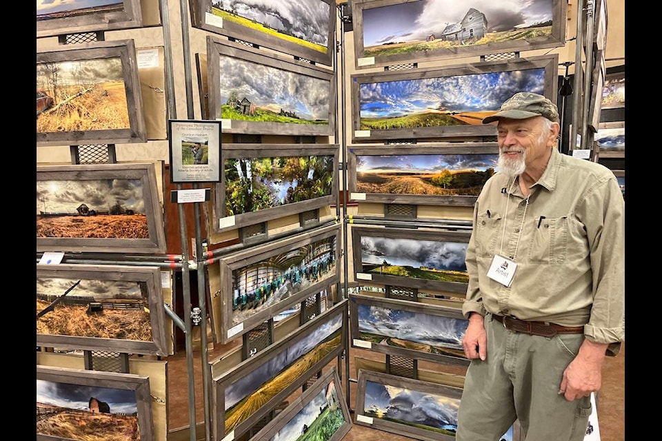 The Encore Art Sale is set to run at the Lacombe Memorial Centre April 11-12. Photographer Gordon Hiebert poses with his works during last year's event (Express file photo)