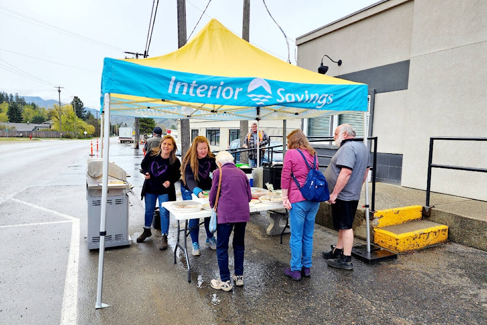 The Interior Savings and Insurance annual Barriere Garage Sale was a huge success on Friday April 25 bringing in a whopping $2547.17 all by sales donations for items, clothing, food, baked goods and lemonade. Proceeds from this event go back to the community from a variety of events throughout the year. Interior Savings staff volunteered at the barbecue selling hot dogs, drinks and treats to shoppers. (Photo by: Hettie Buck) 