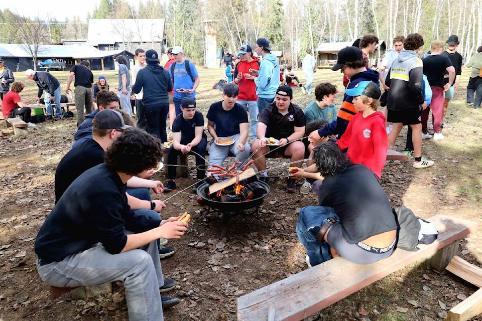 Kamloops and Newfoundland rugby teams, coaches, parents and DOC mayor, Blackwell enjoyed a hot dog roast lunch by the campfire in Wells Gray Park on March 25. (Photo by: Brett Turvey) 