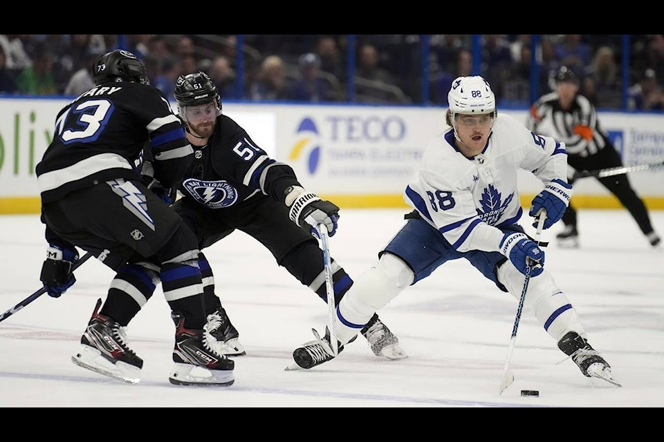 Toronto Maple Leafs right wing William Nylander (88) works around Tampa Bay Lightning left wing Austin Watson (51) and left wing Conor Sheary (73) during the first period of an NHL hockey game Wednesday, April 17, 2024, in Tampa, Fla. The hockey team once played home games at Maple Leaf Gardens. (AP Photo/Chris O’Meara) 