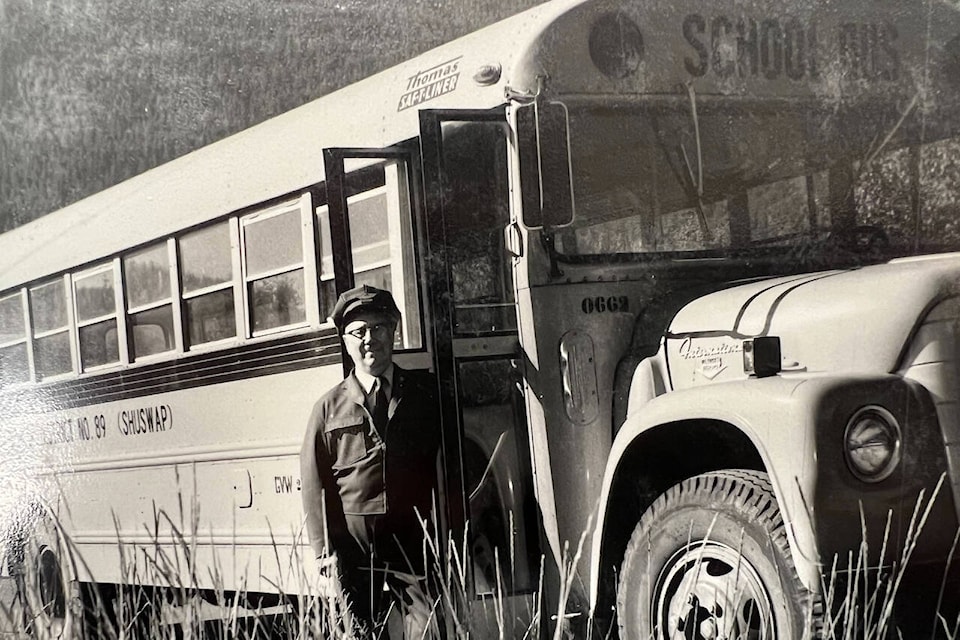 John Pritchard poses with one of his school busses. (Enderby Museum photo) 